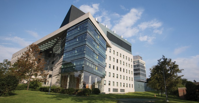 A contemporary glass-windowed office building on sunny day.